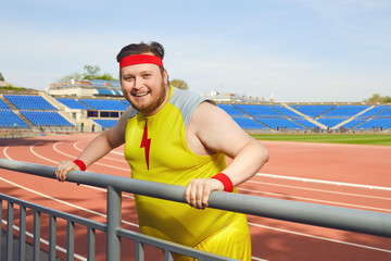 Thick funny man resting after a workout at the stadium.