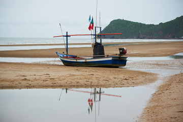 A blue fisherman boat on the beach