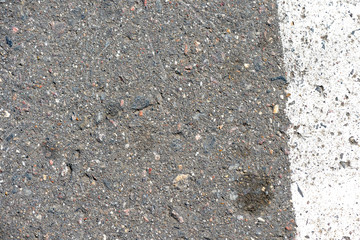Old dirty asphalt texture with white paint on it. Top view