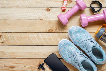 Set of sports accessories for fitness healthy and weight loss dieting concept with exercise equipment on grunge wooden background.