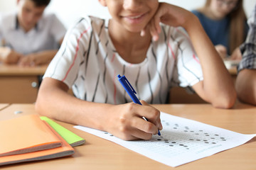 African-American teenage girl passing school test in classroom