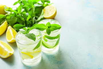 Glasses of fresh mojito on table