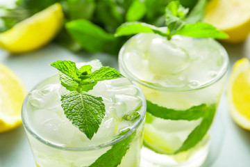 Glasses of fresh mojito on table, closeup
