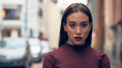 Obraz premium Sad young woman posing on the street.