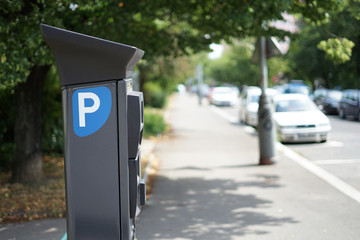 Modern parking pay station on a street allow parkers pay by card or cash - obrazy, fototapety, plakaty