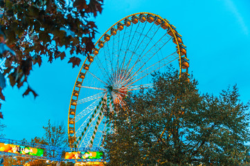 Ferris wheel in motion against blue sky