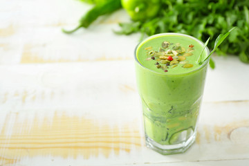 Glass of healthy smoothie on white table