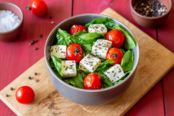 Salad with tomatoes, spinach and cheese. Italian cuisine. Healthy eating. Diet.