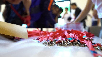 Registration desk with focus on lanyards for participants at a concert, sporting event or seminar - for background