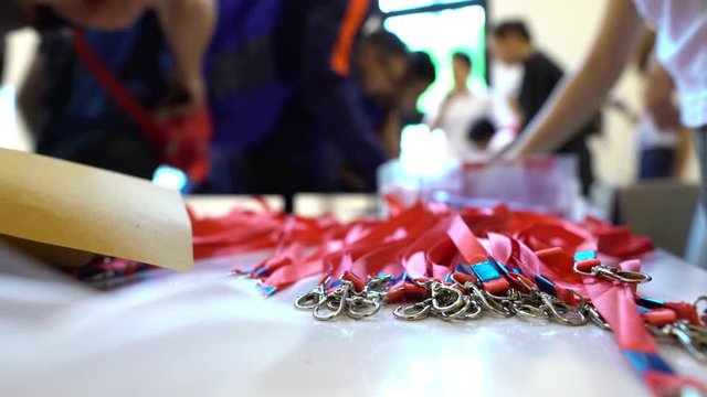 Registration Desk With Focus On Lanyards For Participants At A Concert, Sporting Event Or Seminar - For Background