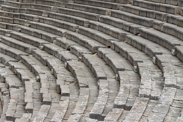 Stairs of the ancient theatre of Epidaurus in the Epidaurus town, on Peloponnesus peninsula, Greece. The theater was dedicated to the ancient Greek God of medicine, Asclepius. Stairs closeup.