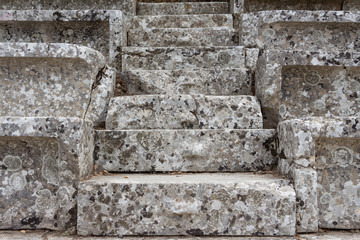 Stairs of the ancient theatre of Epidaurus in the Epidaurus town, on Peloponnesus peninsula, Greece. The theater was dedicated to the ancient Greek God of medicine, Asclepius. Stairs closeup.