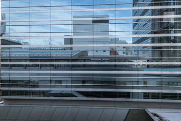 monorail station and building reflected in windows of modern new facade in Tokyo