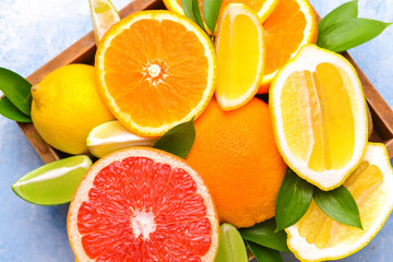 Different citrus fruits in box, closeup