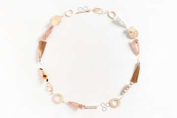 Round frame made of earrings, rings, hairpins on white background