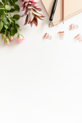 Border frame made of flowers and stationery on white background