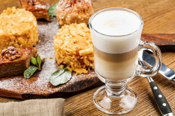 A glass of delicious latte on wooden table.