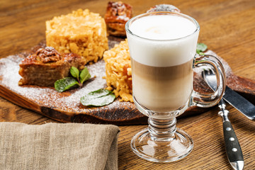 A glass of delicious latte on wooden table.