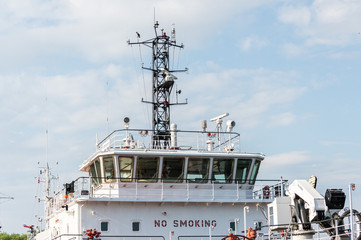 Ship bridge for navigation and control. Cargo ship waiting for a captain and crew. Vessel is ready to shove off and start new voyage. © TRAVELARIUM
