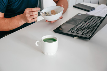 freelancer has breakfast front laptop