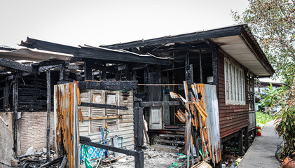 The old wooden house in the slum caused a fire in the ruins.