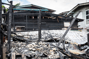 The old wooden house in the slum caused a fire in the ruins.