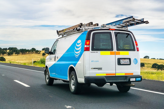 June 28, 2019 Oakdale / CA / USA - AT&T service van driving on the freeway; emblem displayed on the side
