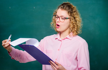 Read impressing resume. School project. Literature teacher read composition. Woman smart lady hold...