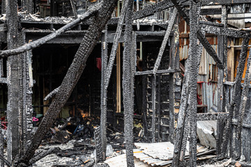 The old wooden house in the slum caused a fire in the ruins.