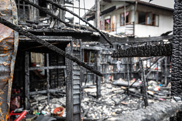 The old wooden house in the slum caused a fire in the ruins.