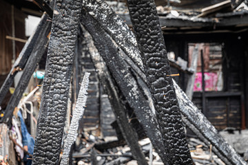 The old wooden house in the slum caused a fire in the ruins.