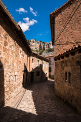 Fototapeta na wymiar lonely streets on a sunny day of beautiful little town Orbaneja del Castillo in Burgos, Spain, with old stone houses
