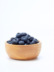 blueberry in wooden bowl on white background