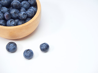 blueberry in wooden bowl on white background