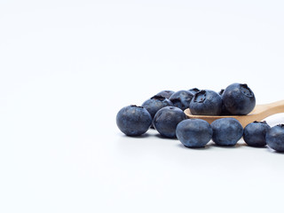 Fototapeta na wymiar blueberry in wooden bowl on white background