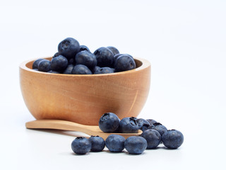blueberry in wooden bowl on white background