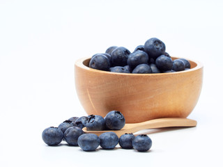 blueberry in wooden bowl on white background