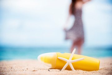 Sunscreen lotion protect woman skin under sunlight burn with uv spf moisturizer on tropical summer...