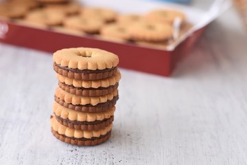 Closeup of delicious chocolate tea biscuits at light wooden background