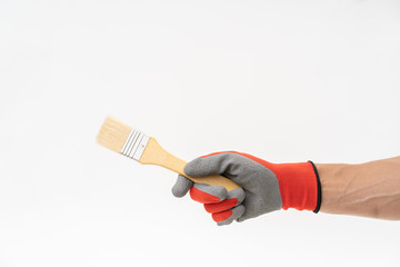 Man hand with red anti slip glove holding paint brush