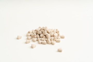 White vitamin pills on white background