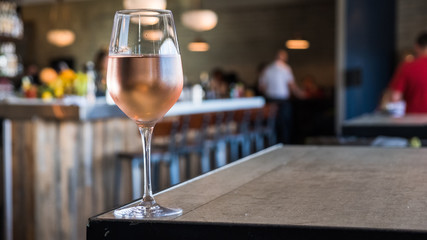 Glass of rose on table