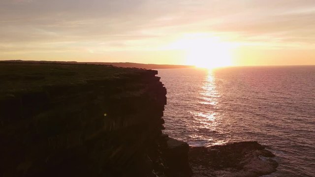 AERIAL DOLLY IN TILT DOWN Flying over Carrowmore Lacken cliff at sunset