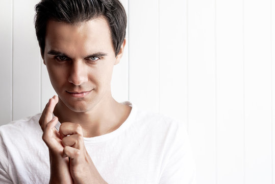 I'll show you. Young guy looking wily. Human emotions and facial expressions. Copy space on the right side