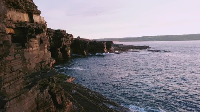 PARALLAX REVEALING Impressive rock formations on cliff side in Ireland at sunset