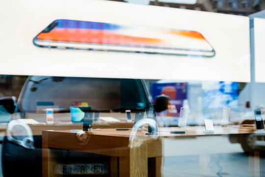 STRASBOURG, FRANCE - NOV 3, 2017: City reflection with latest Apple iPhone X goes on sale in Apple Store worldwide