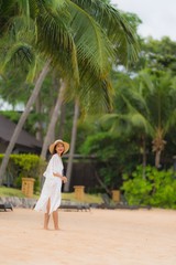 Portrait beautiful young asian woman smile happy relax on the beach sea ocean