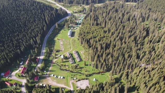 Aerial drone shot above houses in Bucegi Mountains, Romania