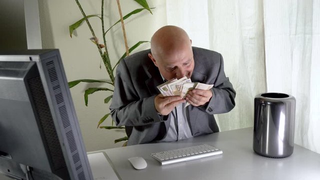 Greedy Businessman Smelling Money and Rubbing Cash All Over Face