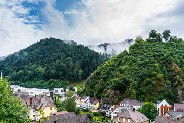 Fototapeta na wymiar Germany, Little black forest town hornberg, world famous for the story of hornberg shooting in green valley between forested mountains in foggy atmosphere